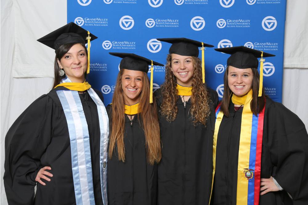 Four upcoming graduates pose together at Gradfest